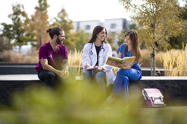 three health profession students sitting outside on auraria campus